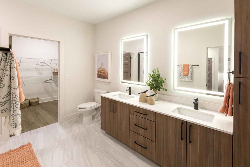 a bathroom with two sinks and a mirror