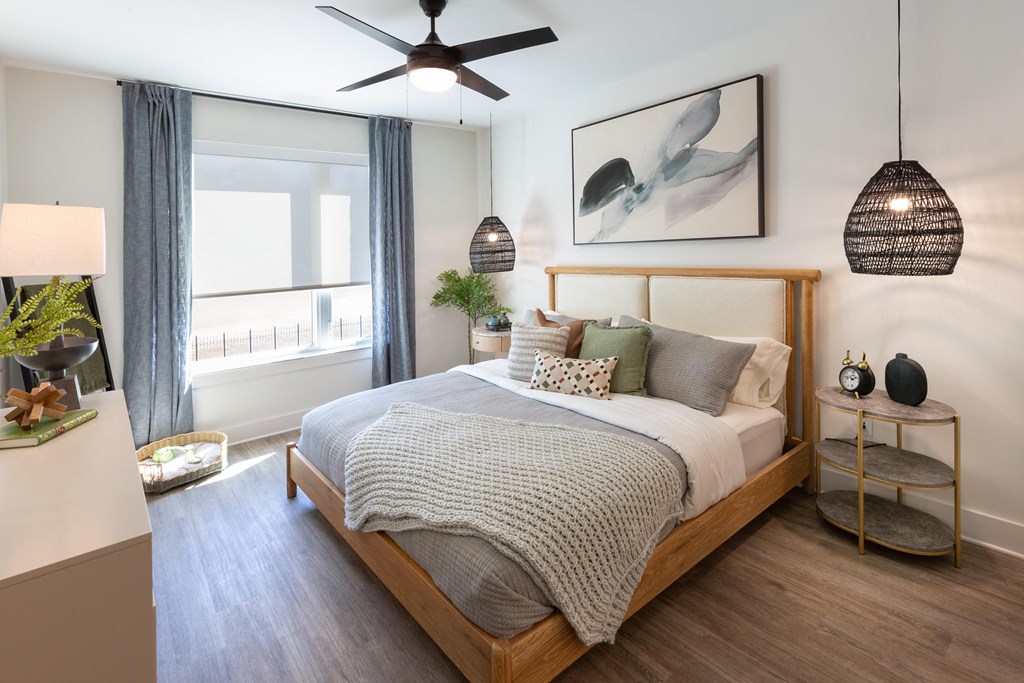 a bedroom with a bed and a ceiling fan