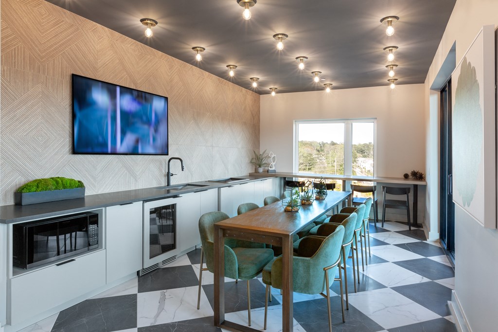 a kitchen and dining room with a long table and chairs