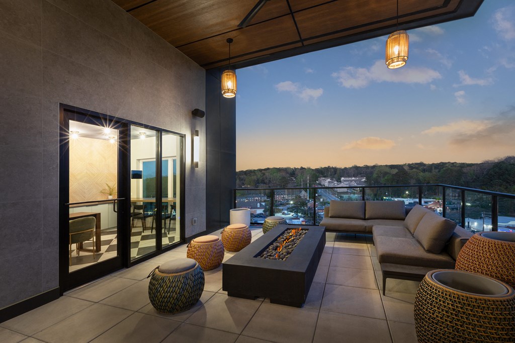 a living room with couches and a coffee table on a balcony