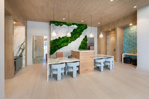 a dining room with a table and chairs in front of a wall with a green