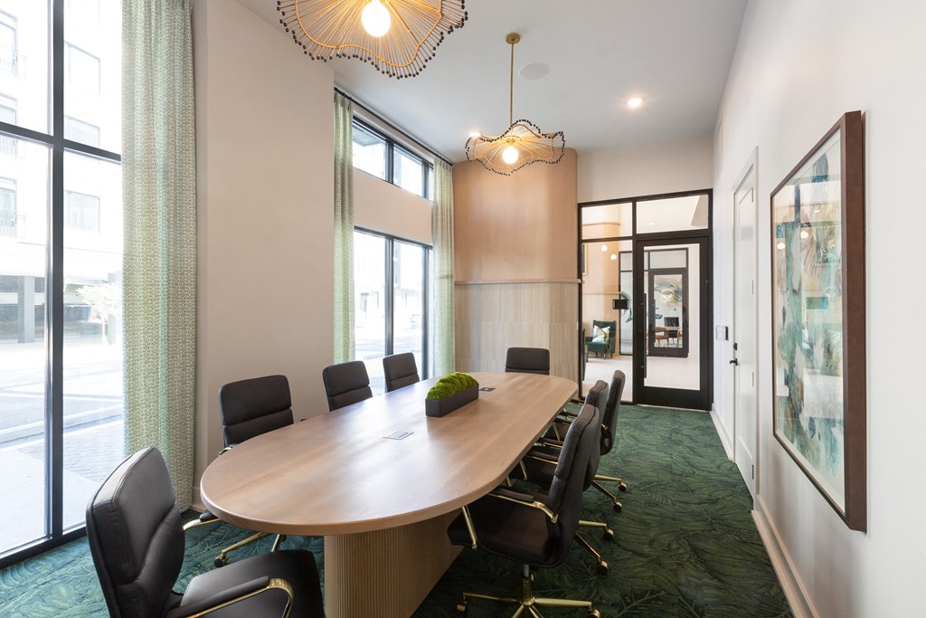 a conference room with a wooden table and chairs