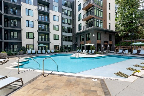 a swimming pool in front of an apartment building