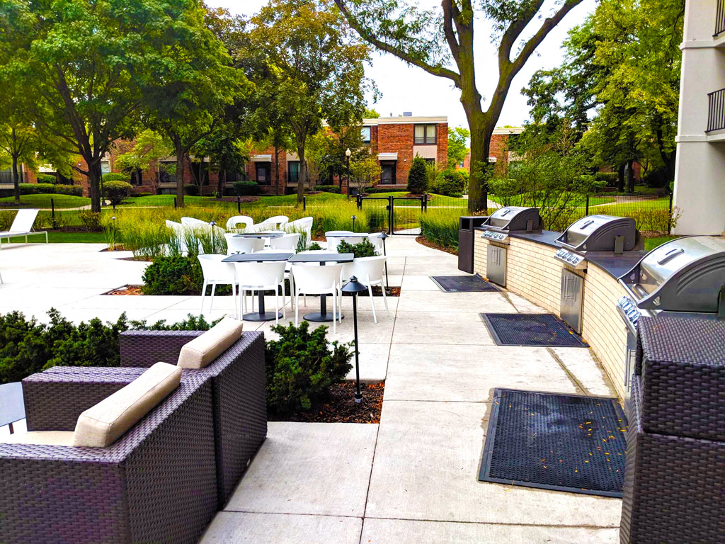 Outdoor grilling area with multiple seating options. 