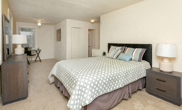 a bedroom with a bed and a dresser