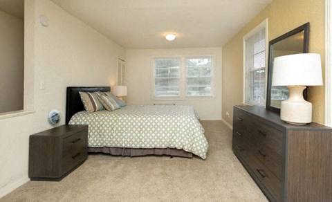 a bedroom with a bed and a mirror