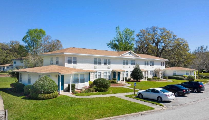 a white house with cars parked in front of it