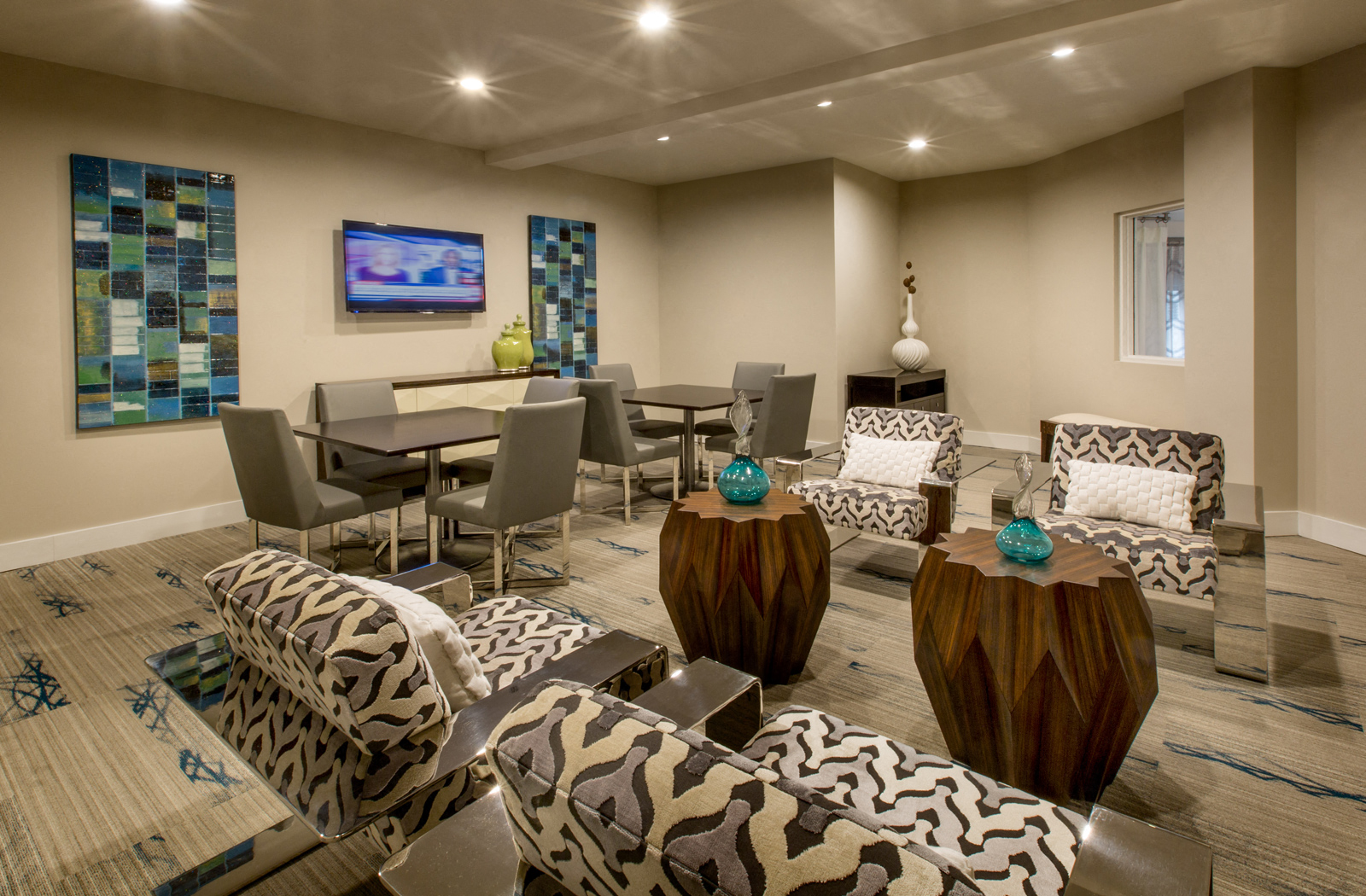 a living room with tables and chairs and a television