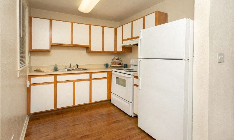 a kitchen with white appliances and white cabinets