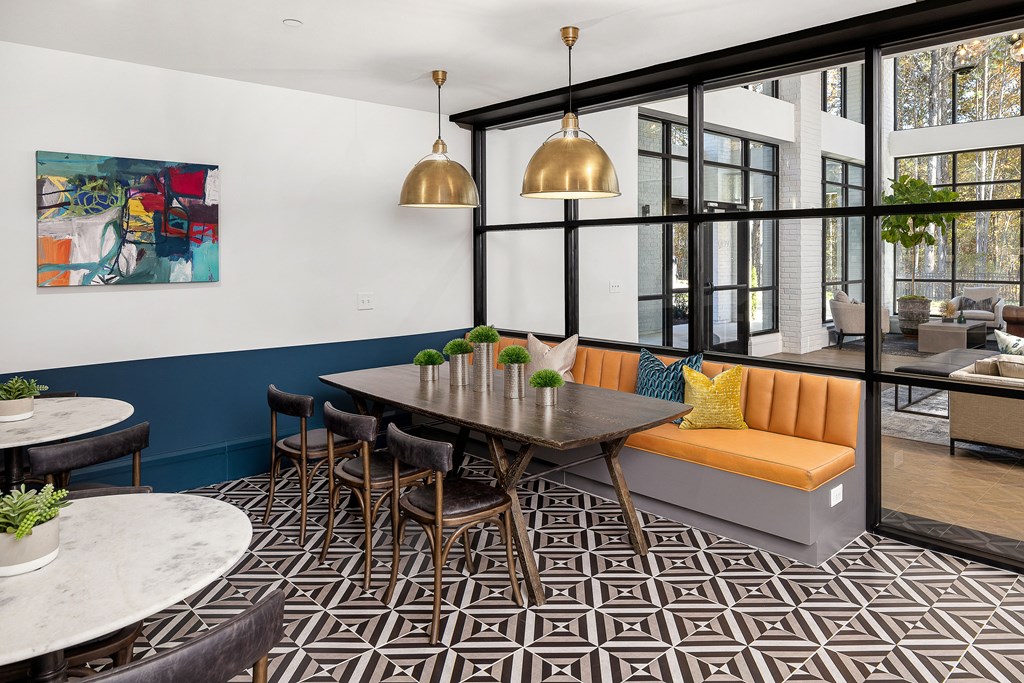 A modern dining area with a black and white patterned floor.