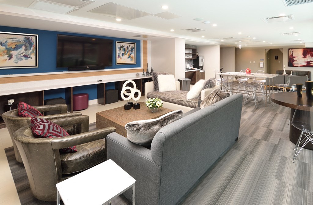 a living room with couches and chairs and a television