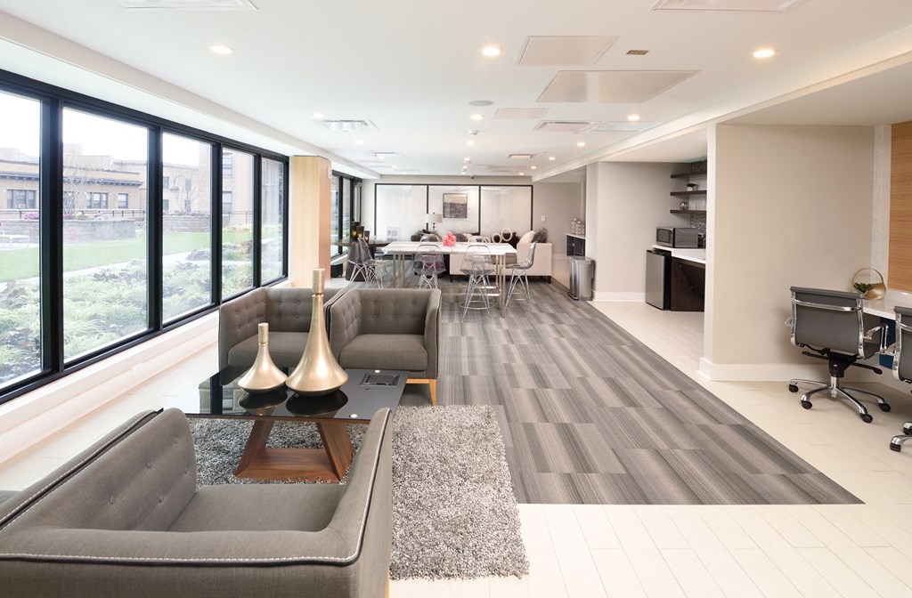 a living room with couches and a table in front of a window