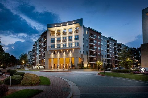 Exterior view of Revel Ballpark Apartments during nighttime. 