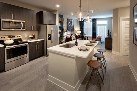 Kitchen with island and dark cabinetry.