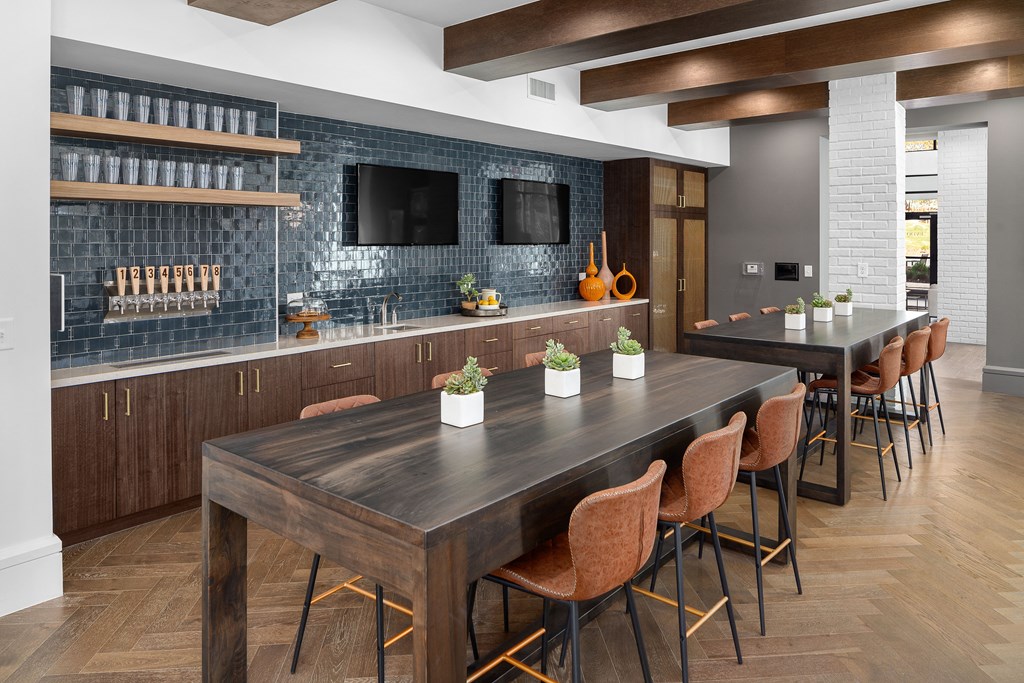 A modern kitchen with a dark wooden table and chairs.