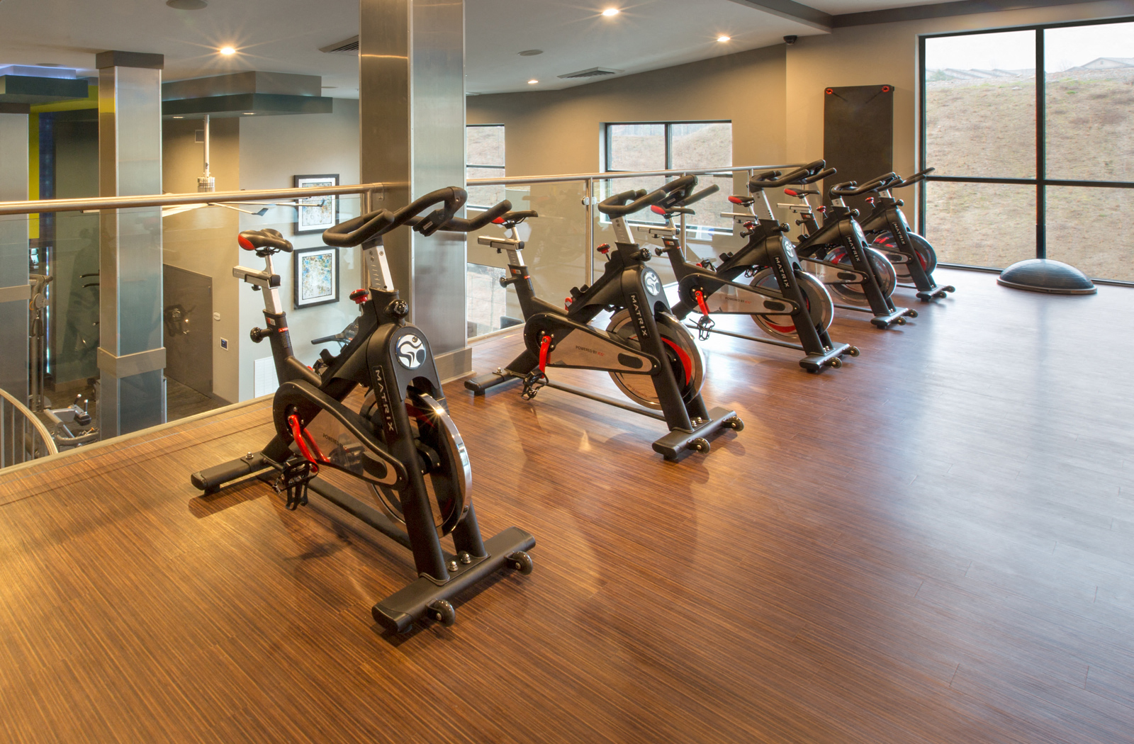 5 exercise bikes on the second level of the fitness center. 