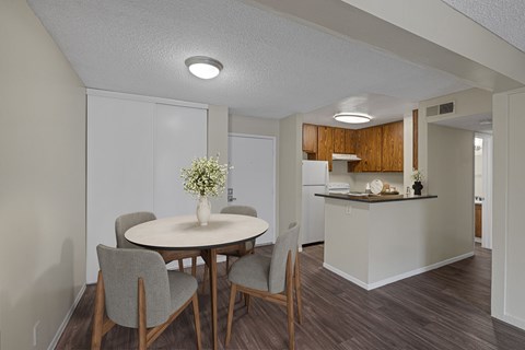 Dining room and kitchen with wood-style vinyl plank flooring.