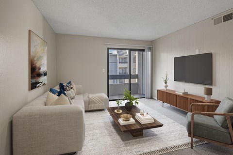 A living room with a grey couch, a wooden coffee table, a grey armchair, a flat screen TV, and a painting on the wall.
