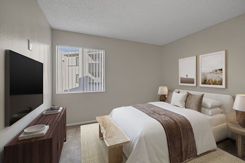 Carpeted bedroom with virtually staged furniture and window.