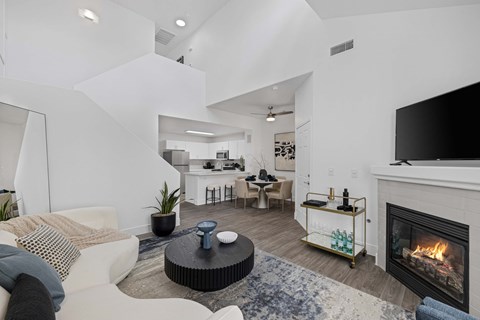 A modern living room with a fireplace and a television.