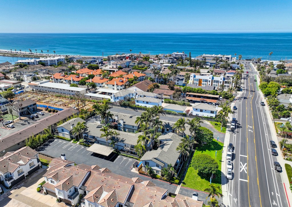 an aerial view of a city with the ocean in the background