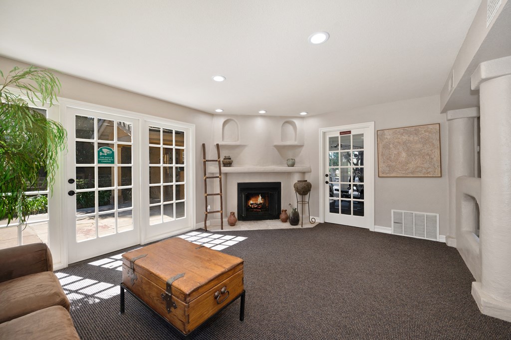 a living room with a fireplace and a coffee table