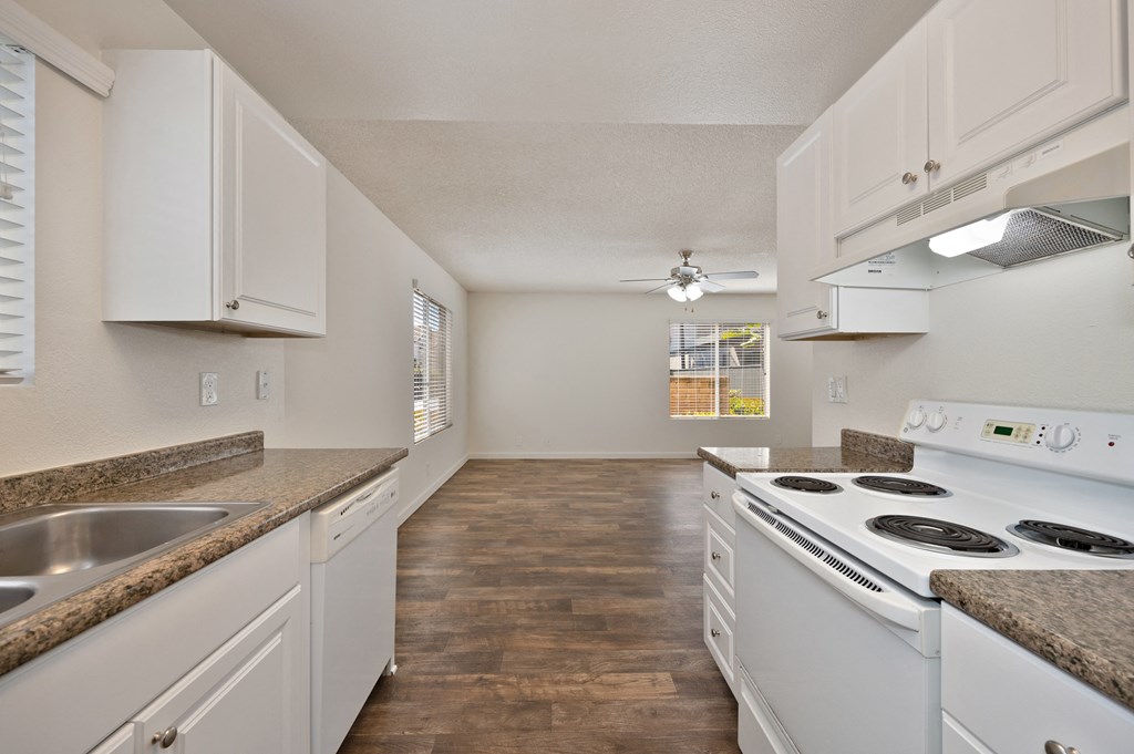 a kitchen with white appliances and white cabinets