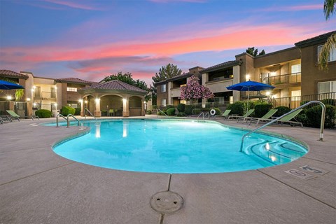 A swimming pool in a residential area surrounded by houses.