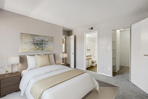 A bedroom with a large bed and a painting on the wall.