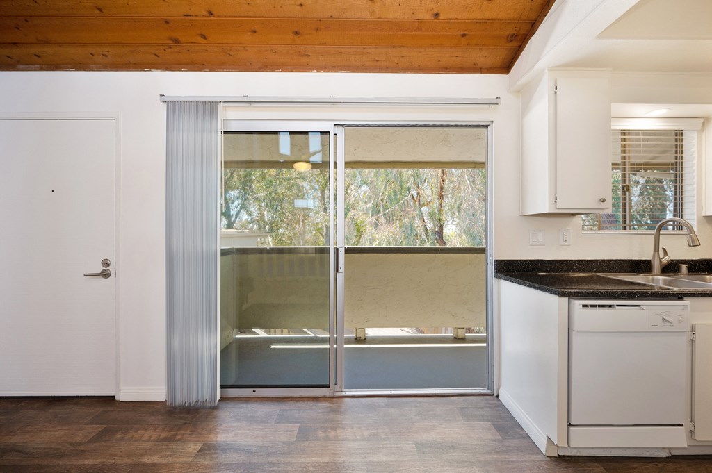a kitchen with a sink and a sliding glass door
