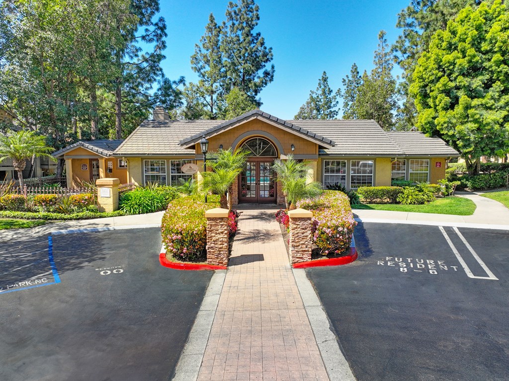 the front of a house with a driveway and a pool