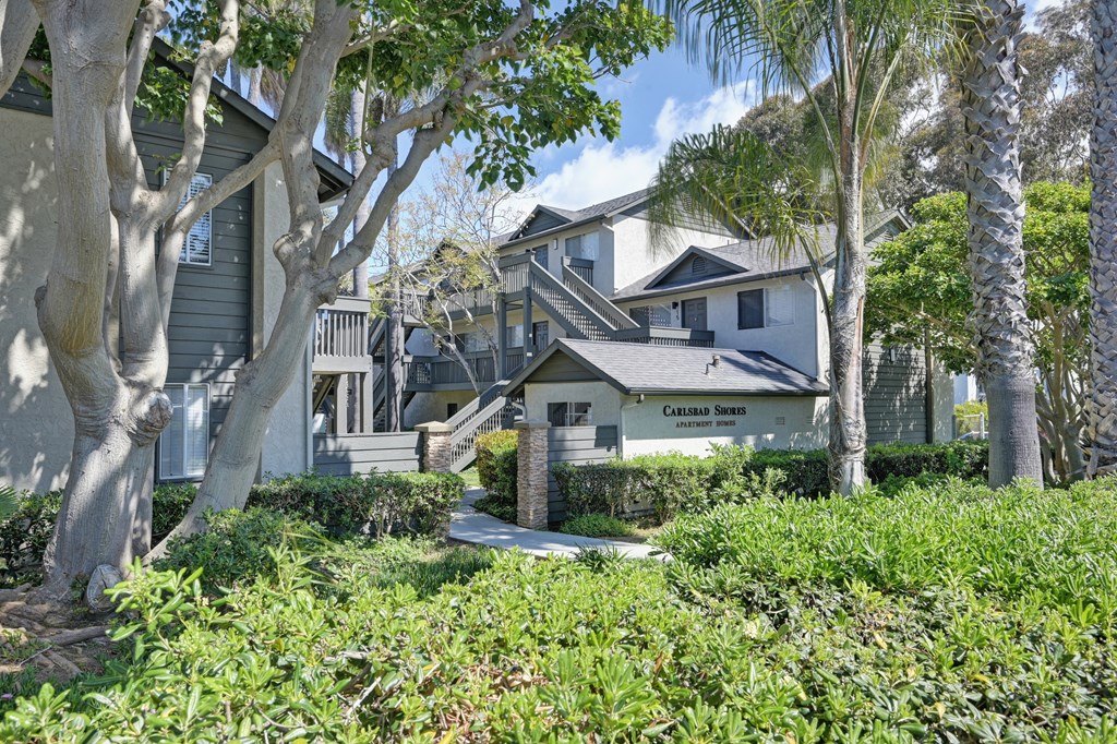 a row of houses with trees in front of them