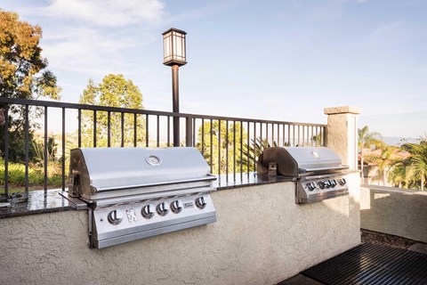 Two built in BBQs on a balcony.