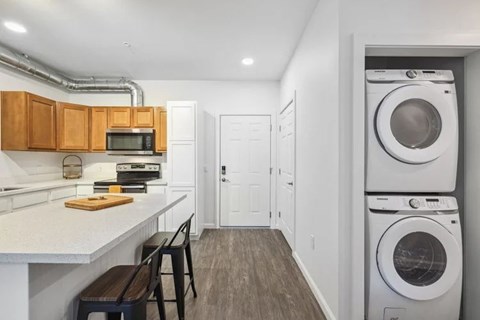 A laundry room with a washer and dryer stacked on top of each other.