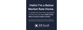 A sign advertising a Below Market Rate Home with income qualification details.