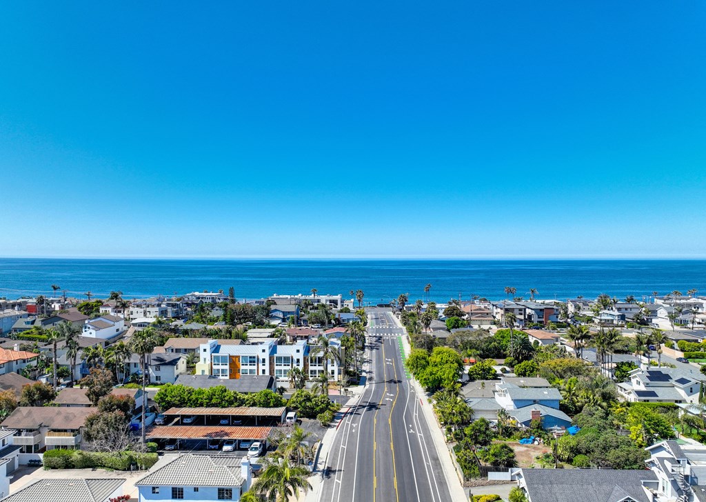 an aerial view of a city and the ocean