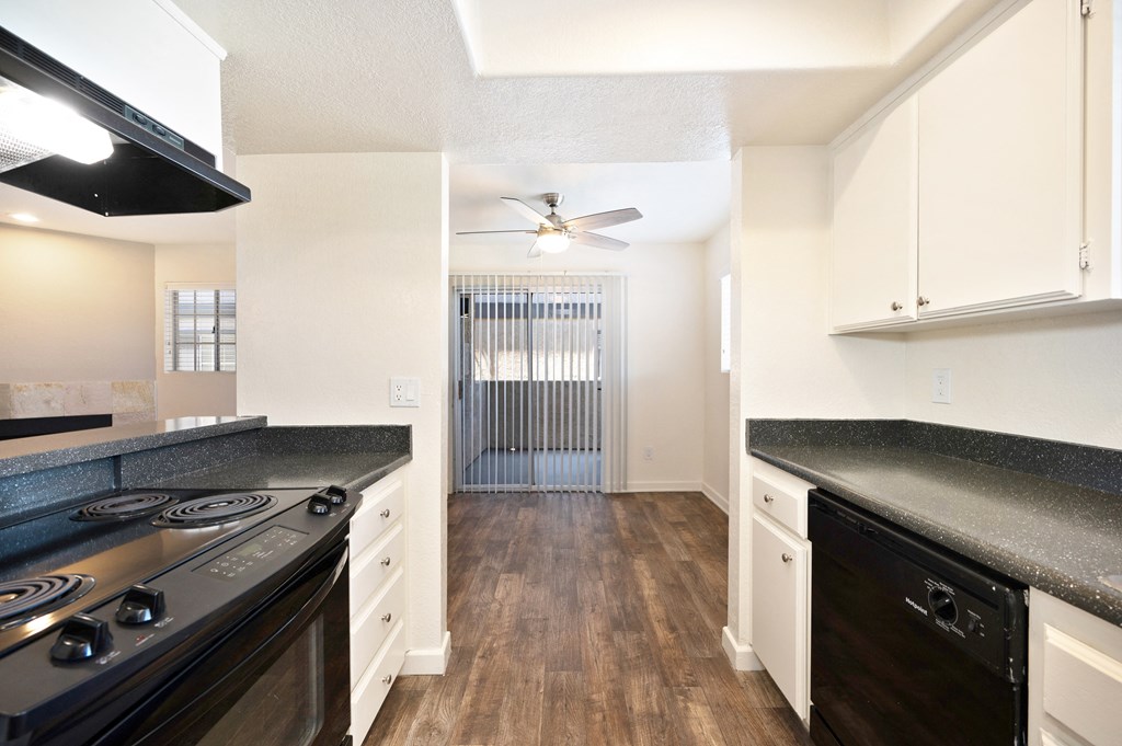 a kitchen with stainless steel appliances and white cabinets