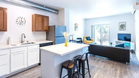 A kitchen with white cabinets and a blue fridge.