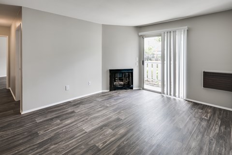 A living room with a fireplace and sliding glass doors.