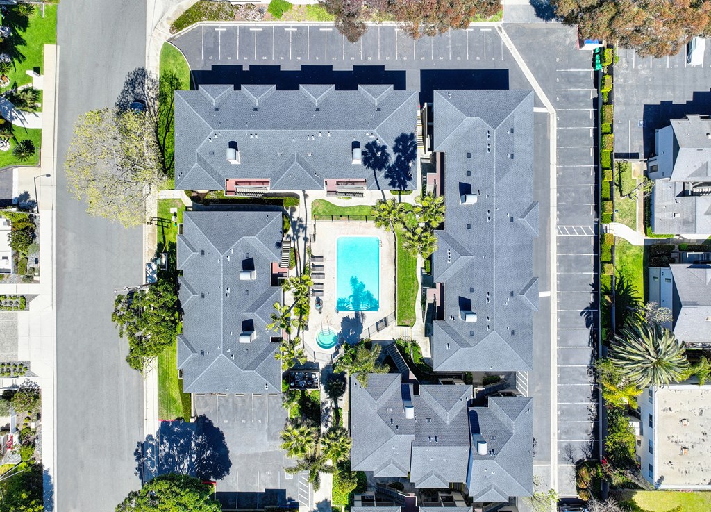 a birdseye view of a house with a pool in the middle of it