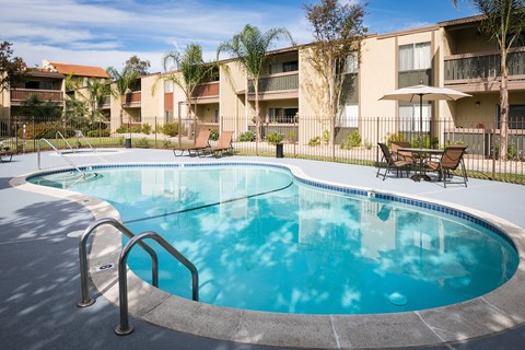 A round swimming pool with a metal ladder in the middle of it.