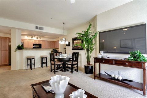 A living room with a dining table and chairs.
