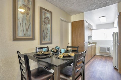 Shared living room and dining room with table, chairs, and view to kitchen.