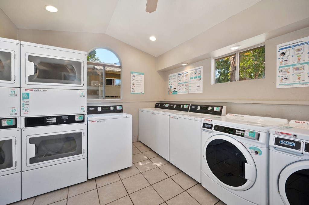 a washer and dryer laundry room with a row of washing machines