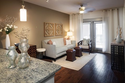 A living room with a white sofa and a wooden floor.