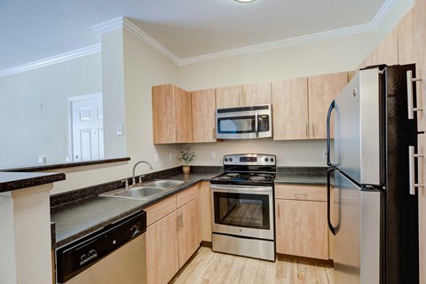 A kitchen with wooden cabinets and stainless steel appliances.