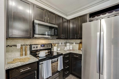 A modern kitchen with a stainless steel refrigerator.