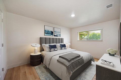 A bedroom with a bed, nightstand, and lamp.