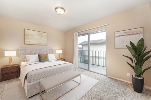 A bedroom with a large bed and a balcony.