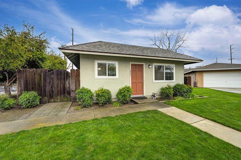 An apartment with a brown door and a brown fence.